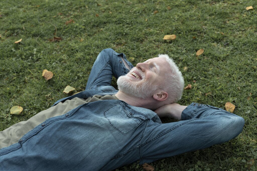 medium-shot-man-laying-grass